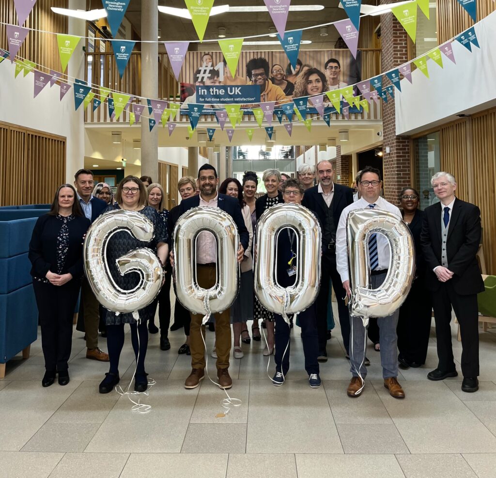 Staff at Birmingham Newman University celebrating the OFSTED report