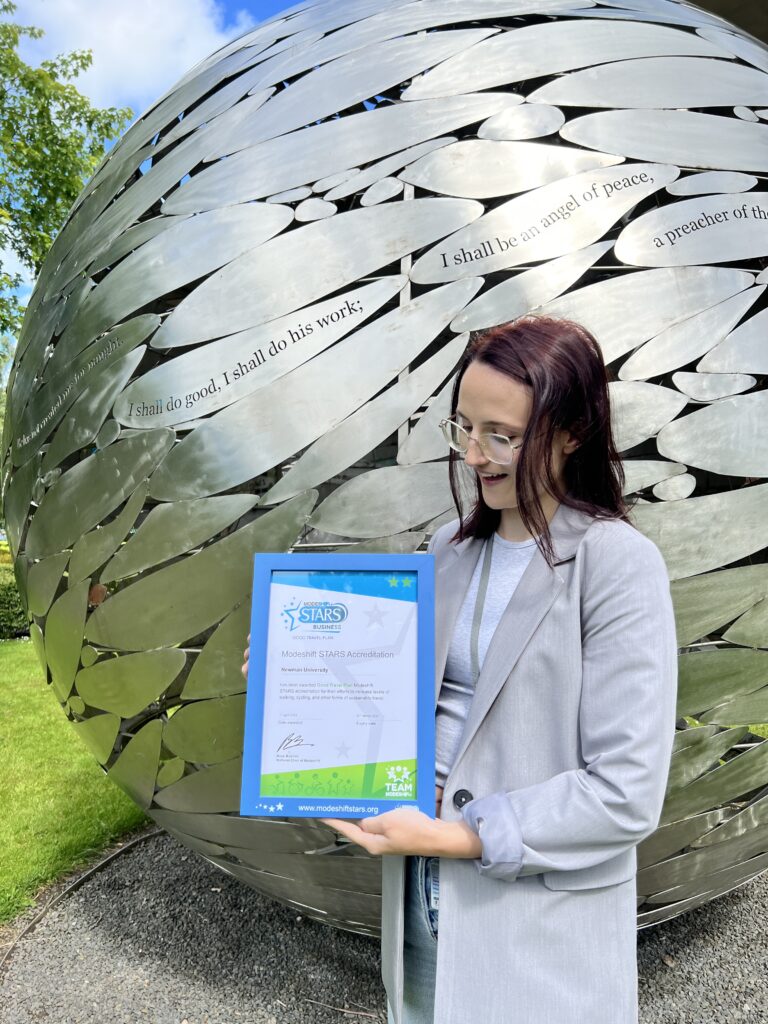 Environmental Advisor Lucy Clarke holding Bronze accreditation certificate for university travel plan