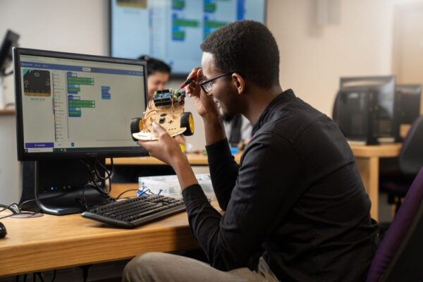 Computer science student fixing a computer
