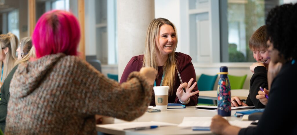 Students studying and talking around a table