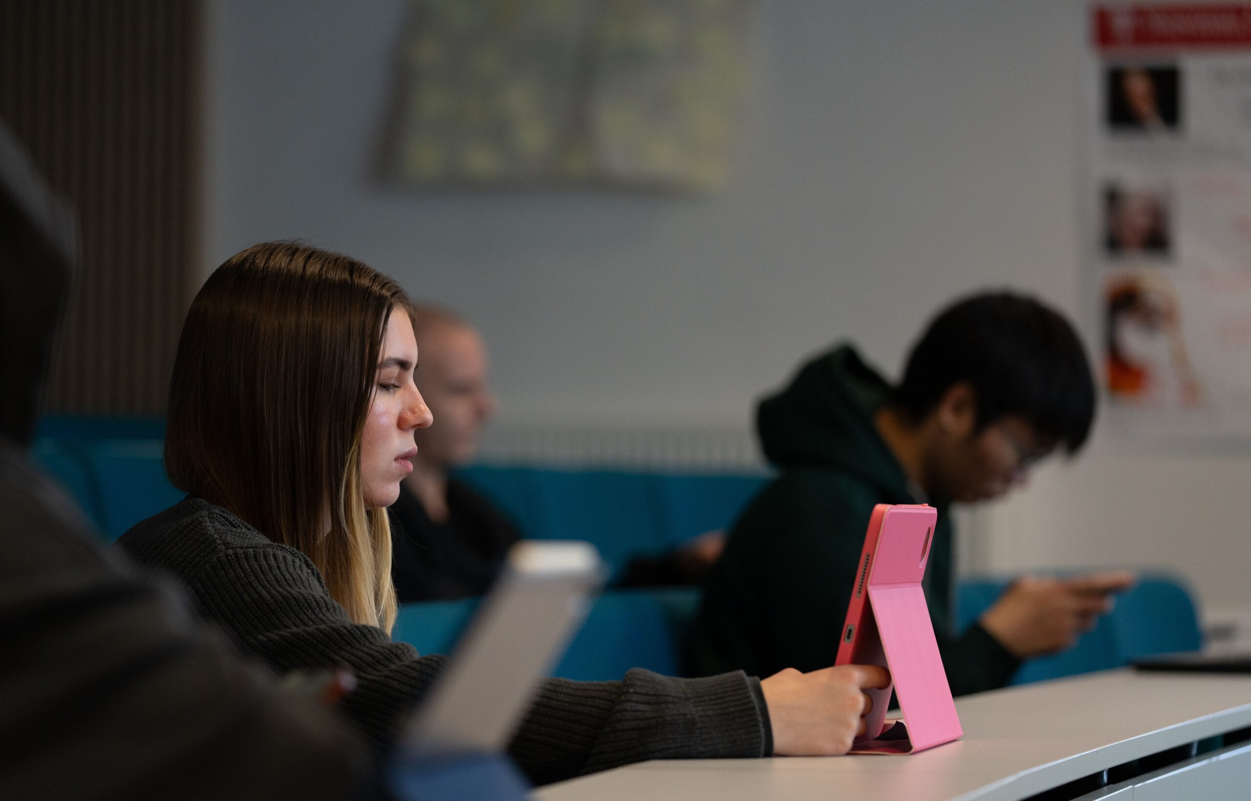 Student on tablet in lecture room